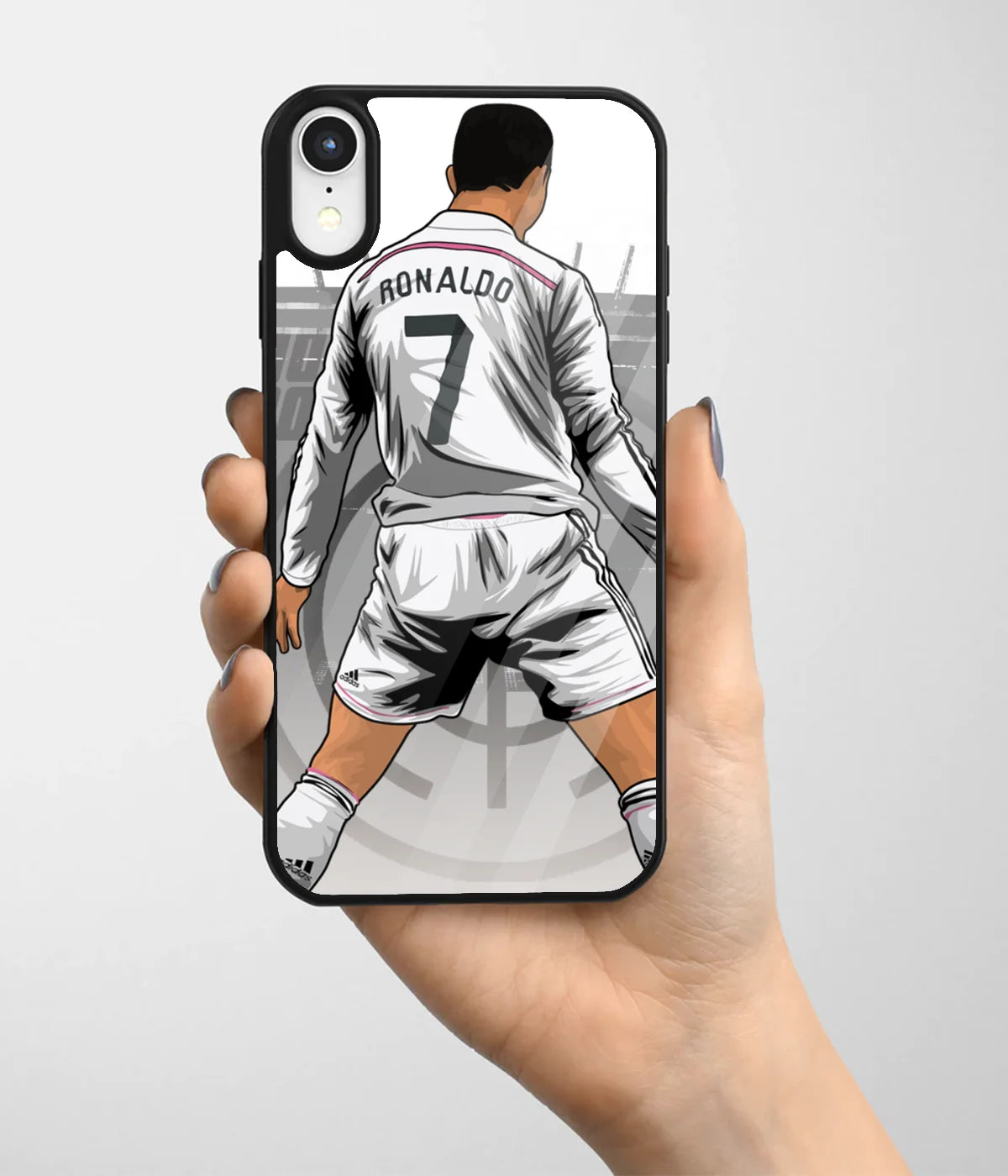 A hand holding a glass phone case with a colorful design.