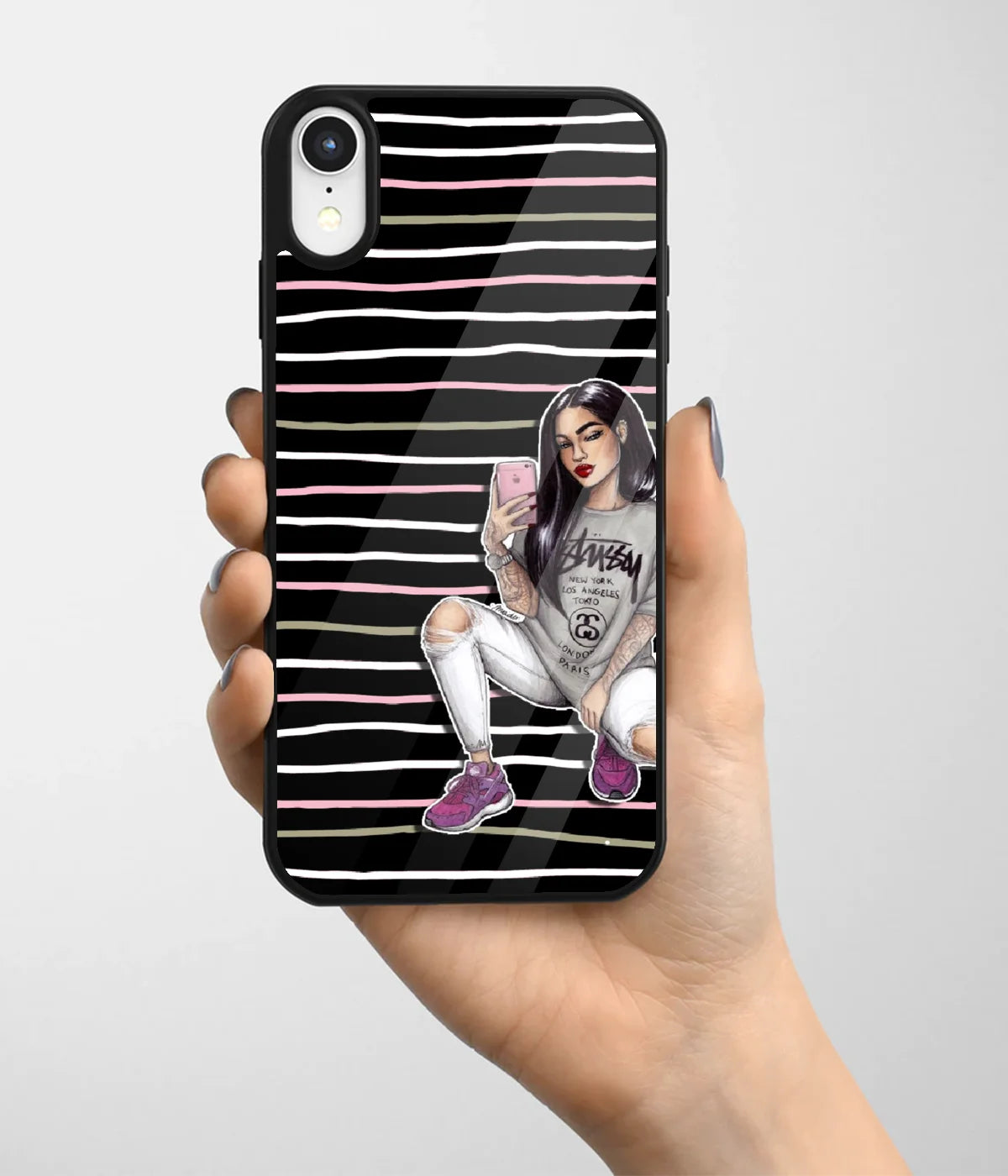 A hand holding a glass phone case with a colorful design.