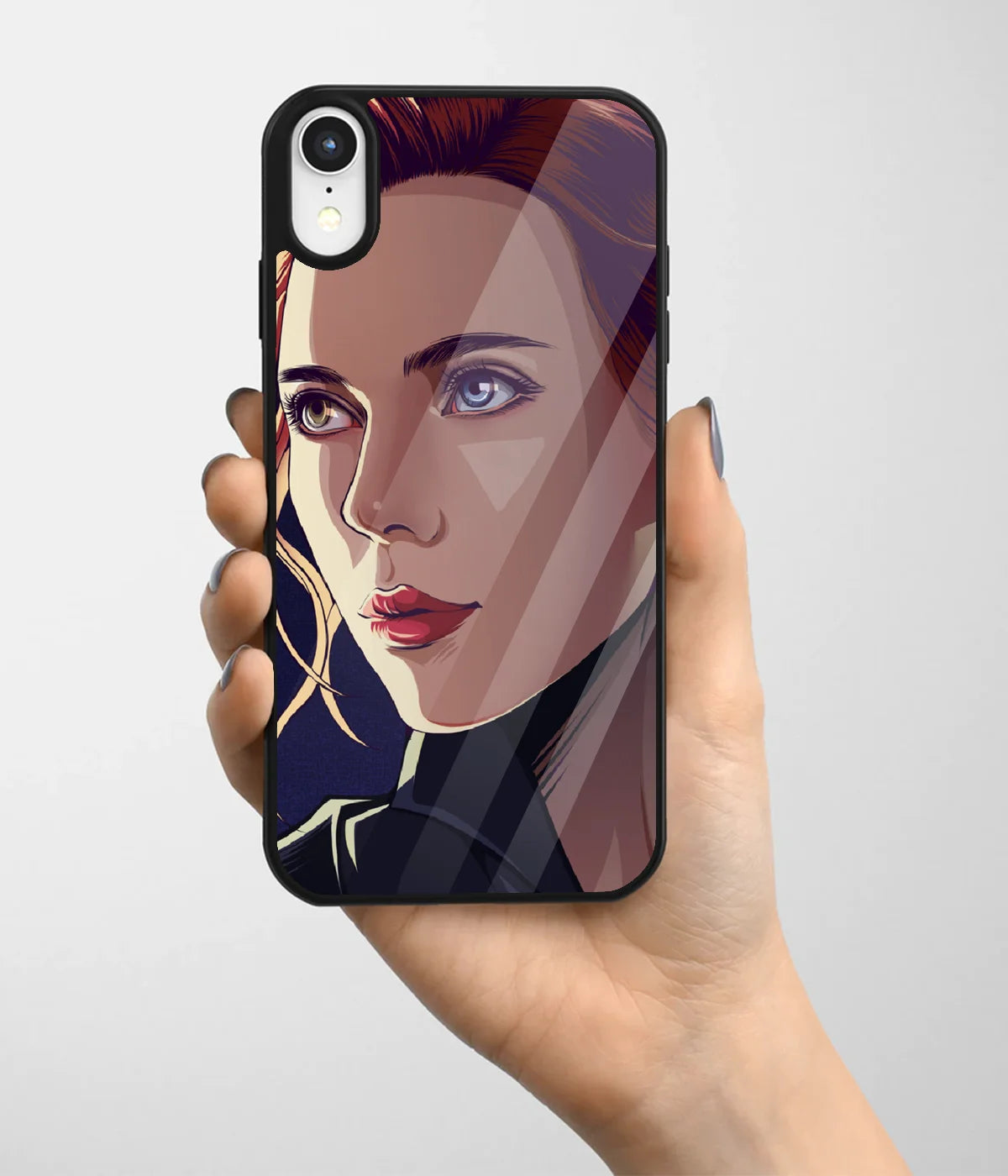 A hand holding a glass phone case with a colorful design.