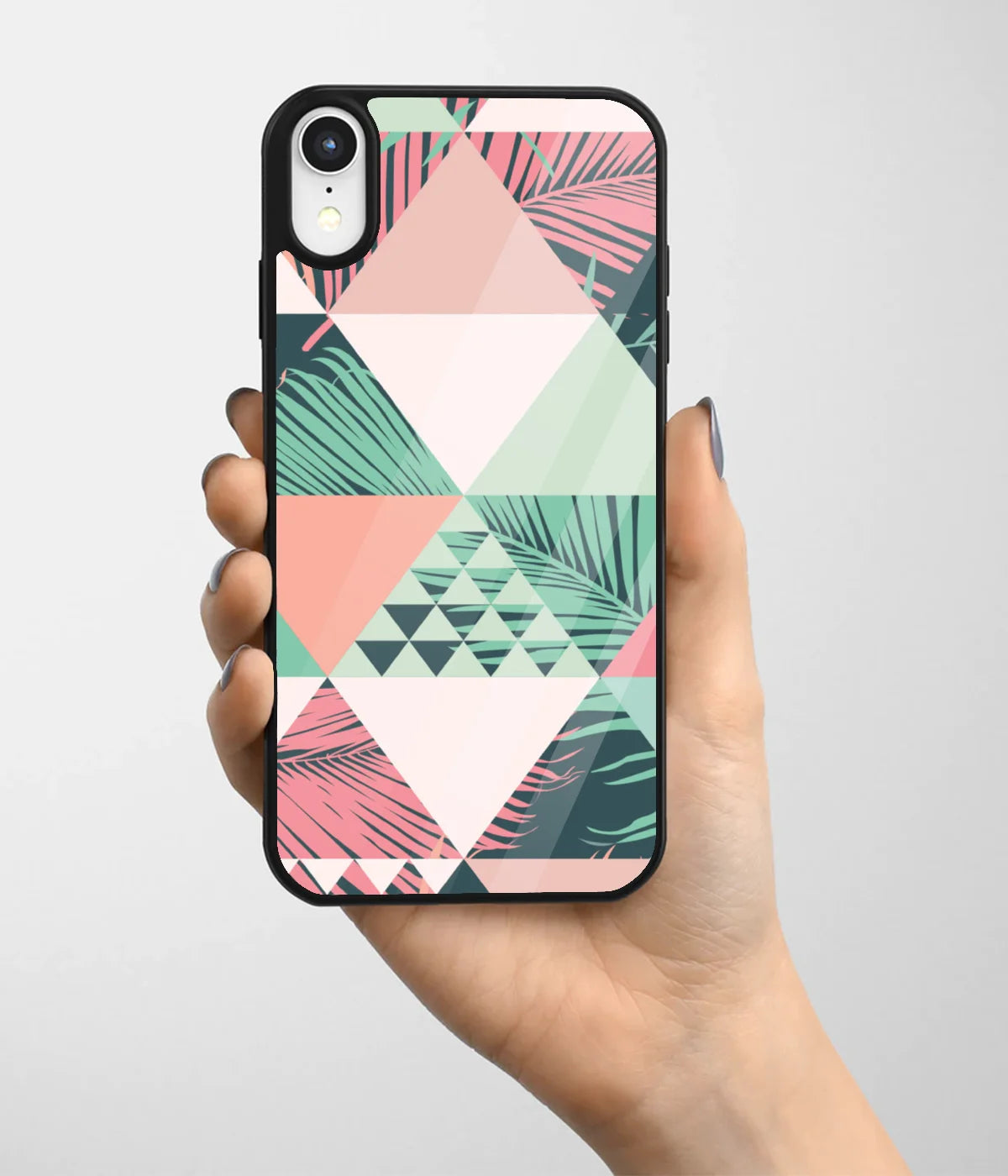 A hand holding a glass phone case with a colorful design.