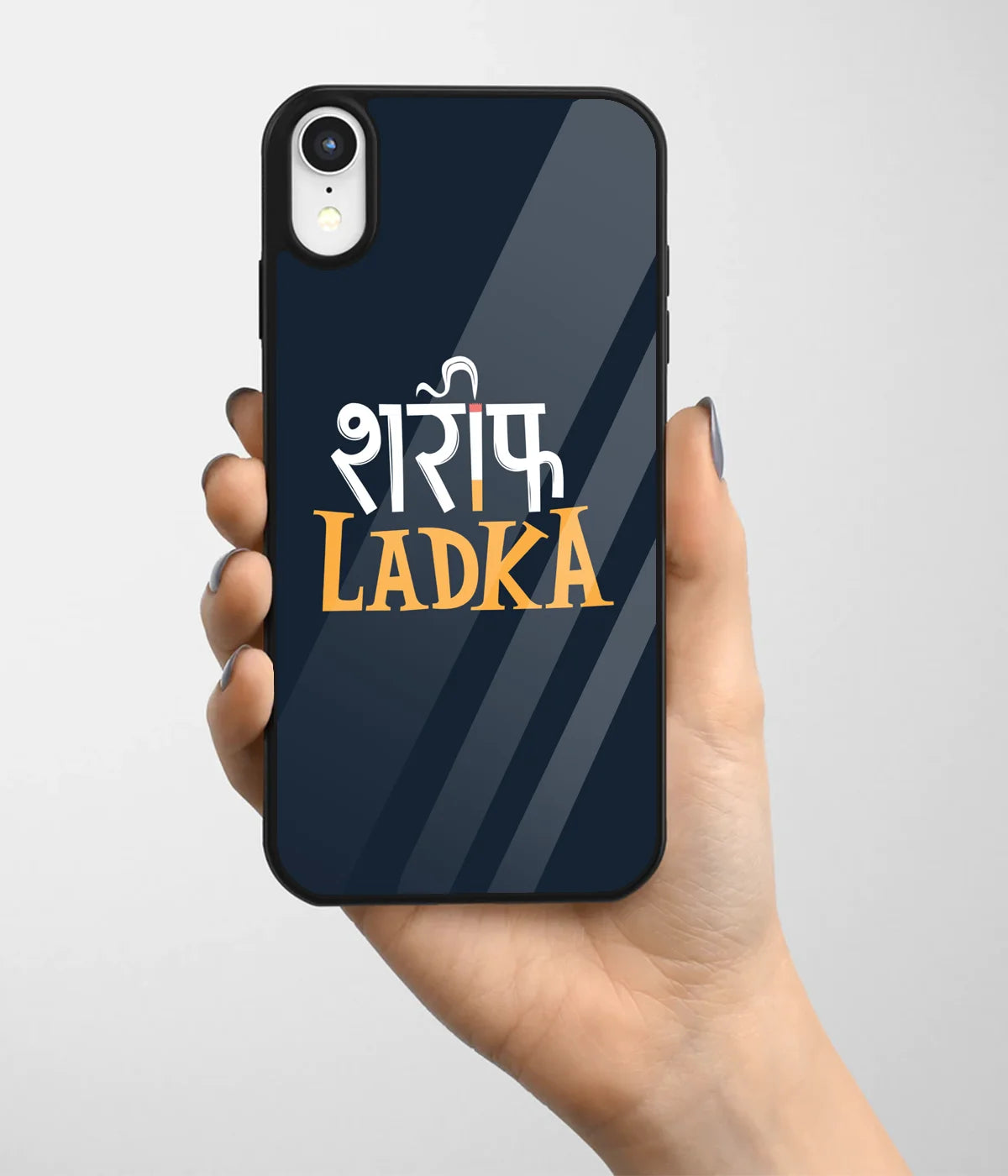 A hand holding a glass phone case with a colorful design.