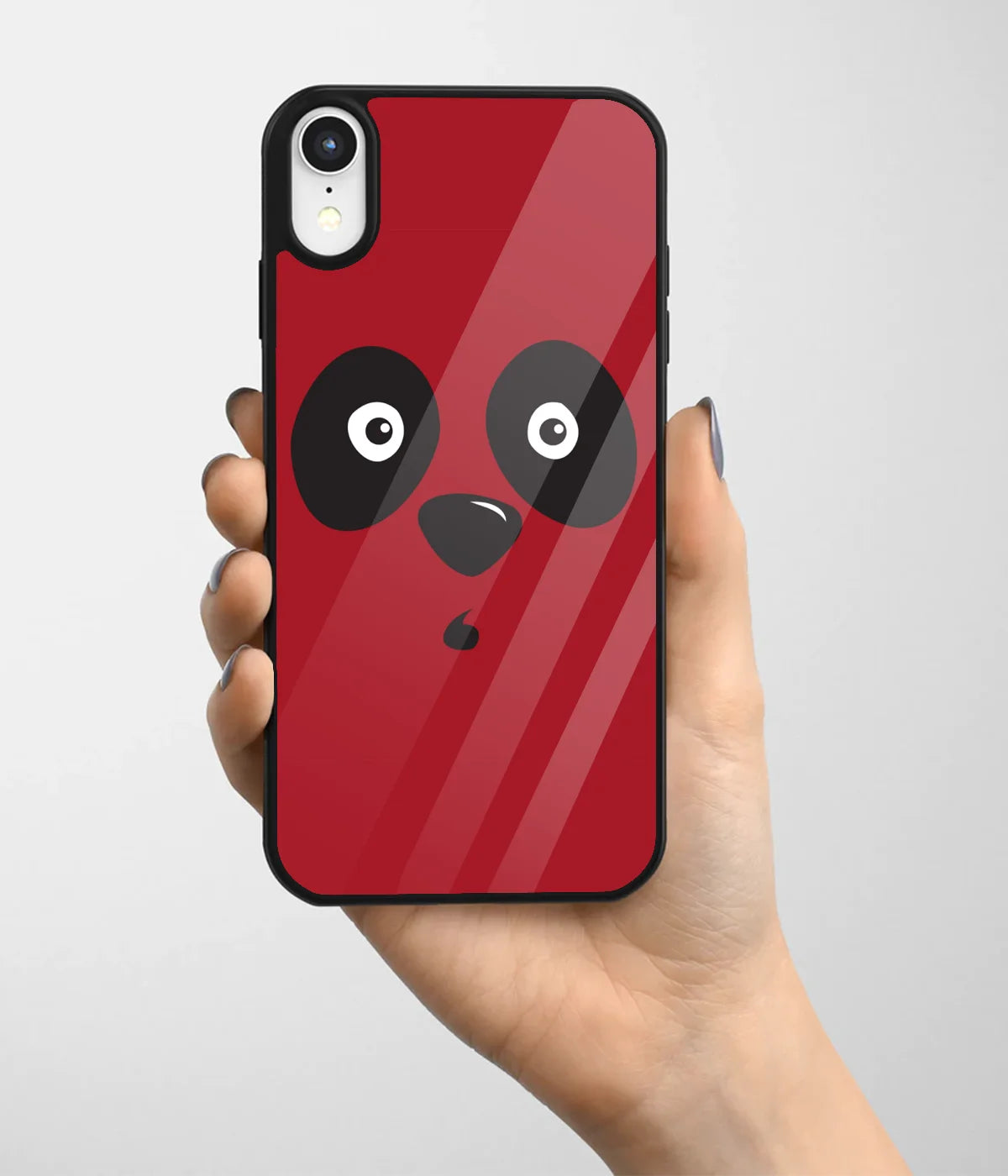 A hand holding a glass phone case with a colorful design.