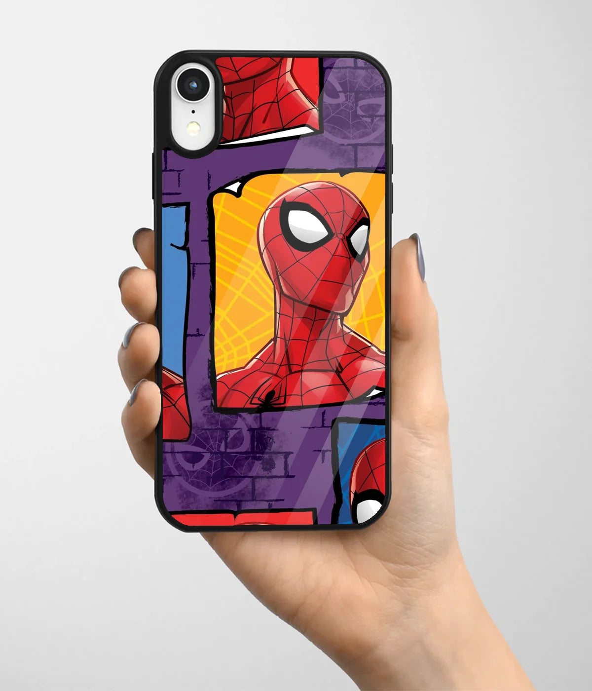 A hand holding a glass phone case with a colorful design.