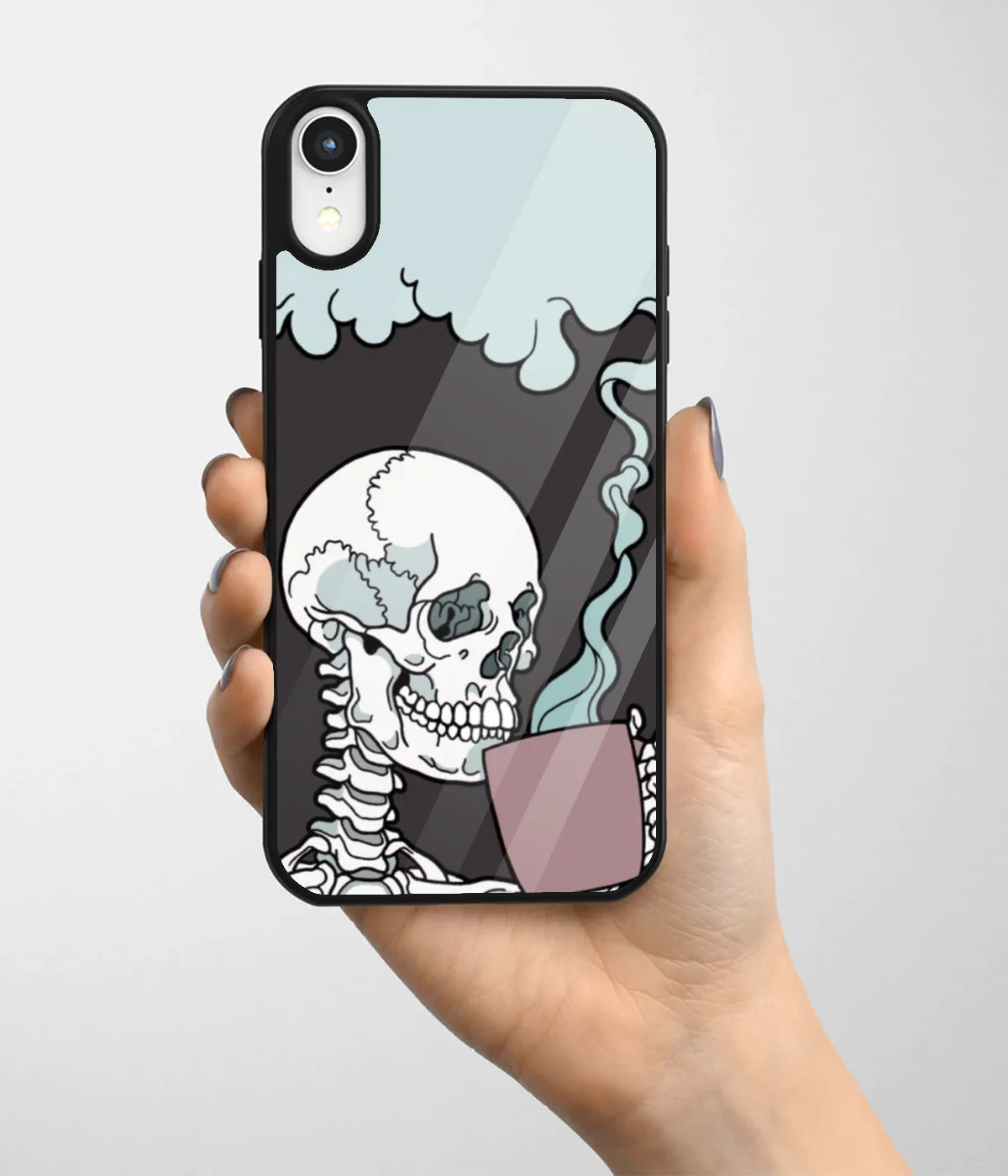 A hand holding a glass phone case with a colorful design.