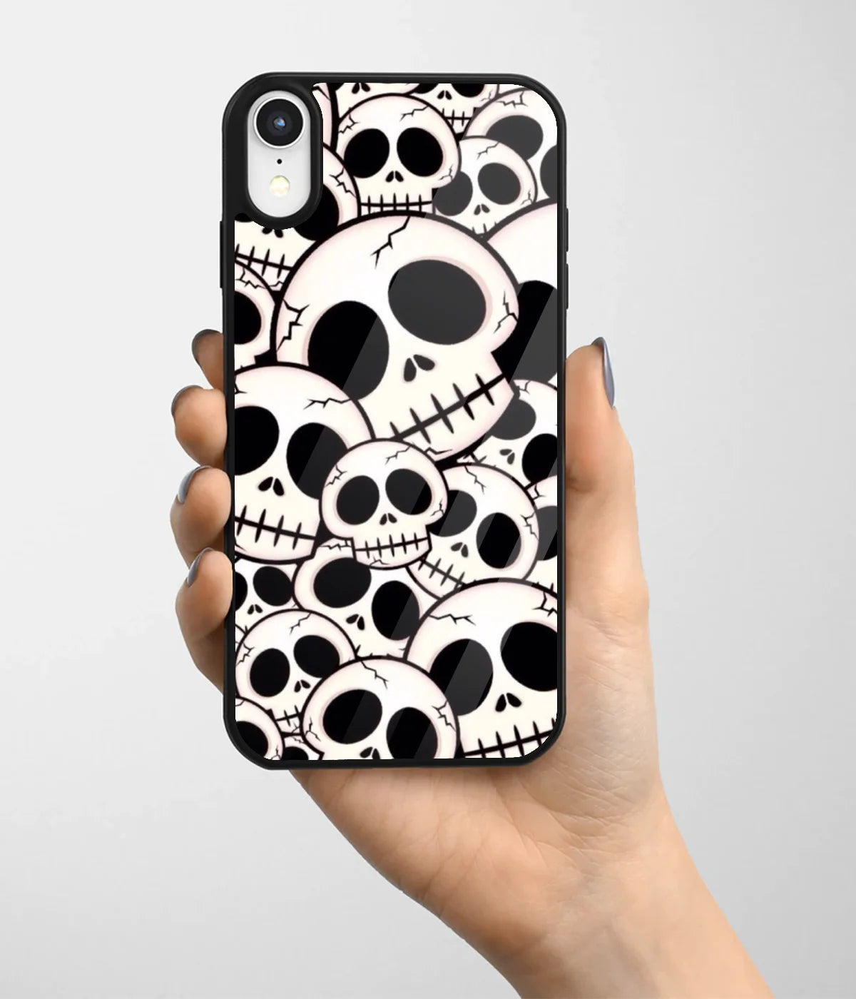 A hand holding a glass phone case with a colorful design.