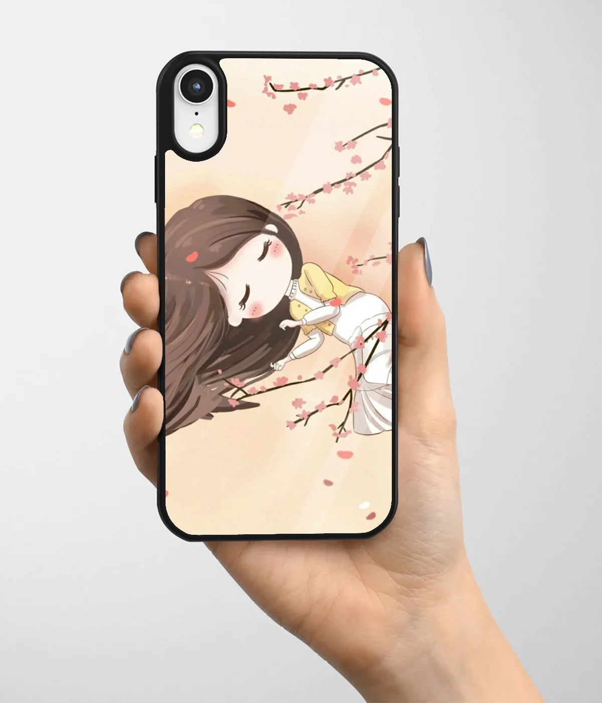 A hand holding a glass phone case with a colorful design.