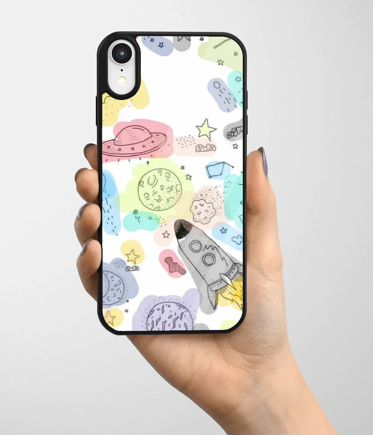 A hand holding a glass phone case with a colorful design.