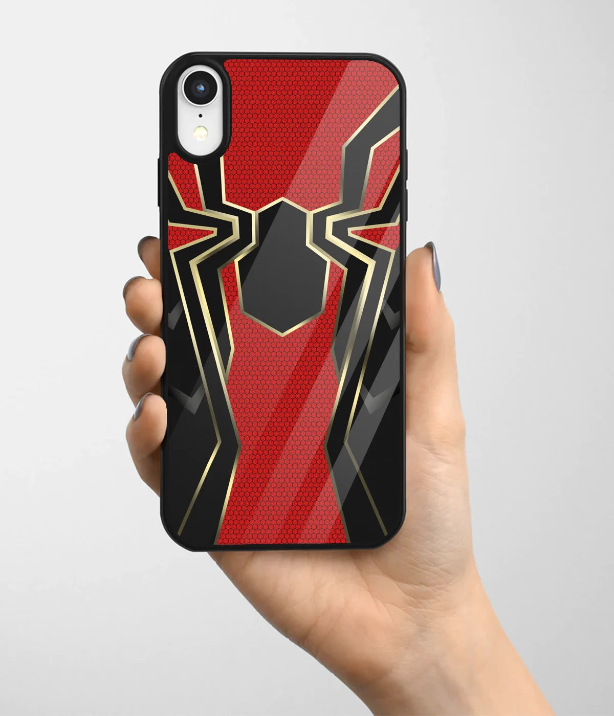 A hand holding a glass phone case with a colorful design.
