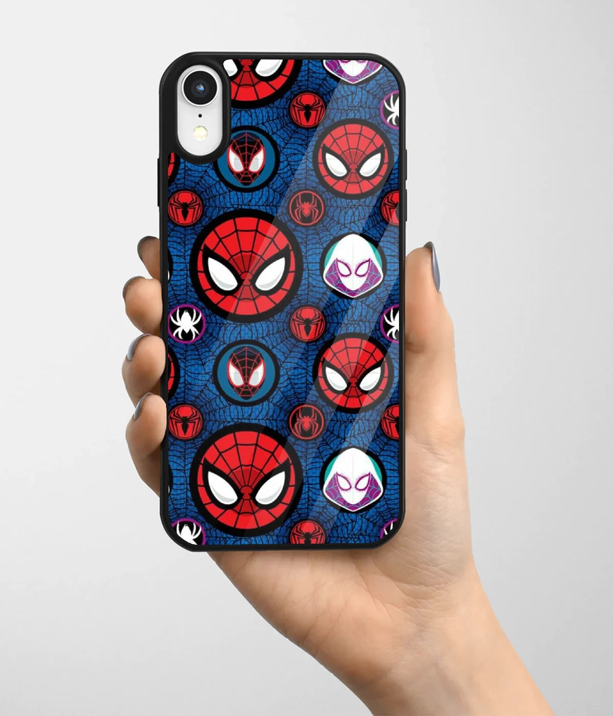 A hand holding a glass phone case with a colorful design.