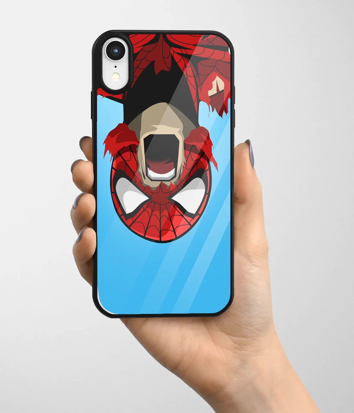 A hand holding a glass phone case with a colorful design.