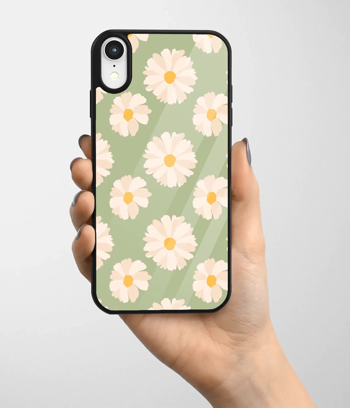 A hand holding a glass phone case with a colorful design.
