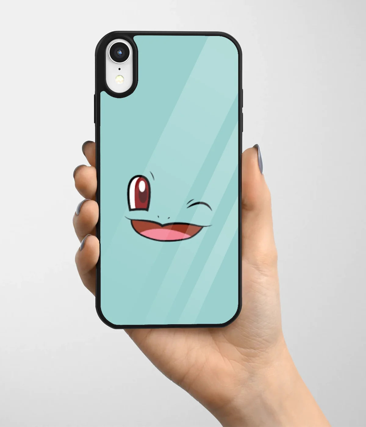 A hand holding a glass phone case with a colorful design.