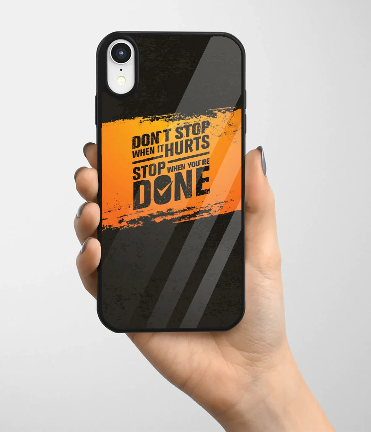 A hand holding a glass phone case with a colorful design.