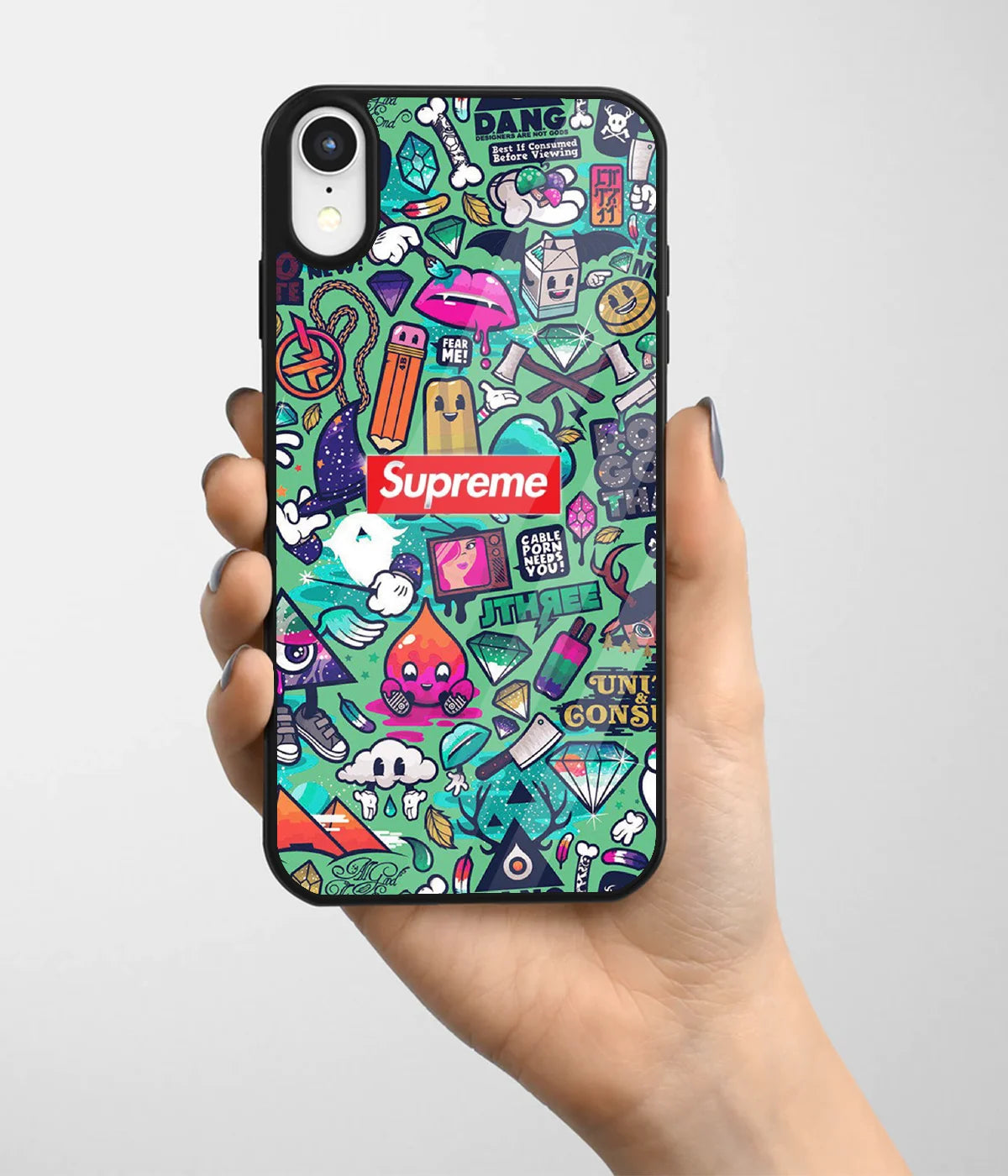 A hand holding a glass phone case with a colorful design.