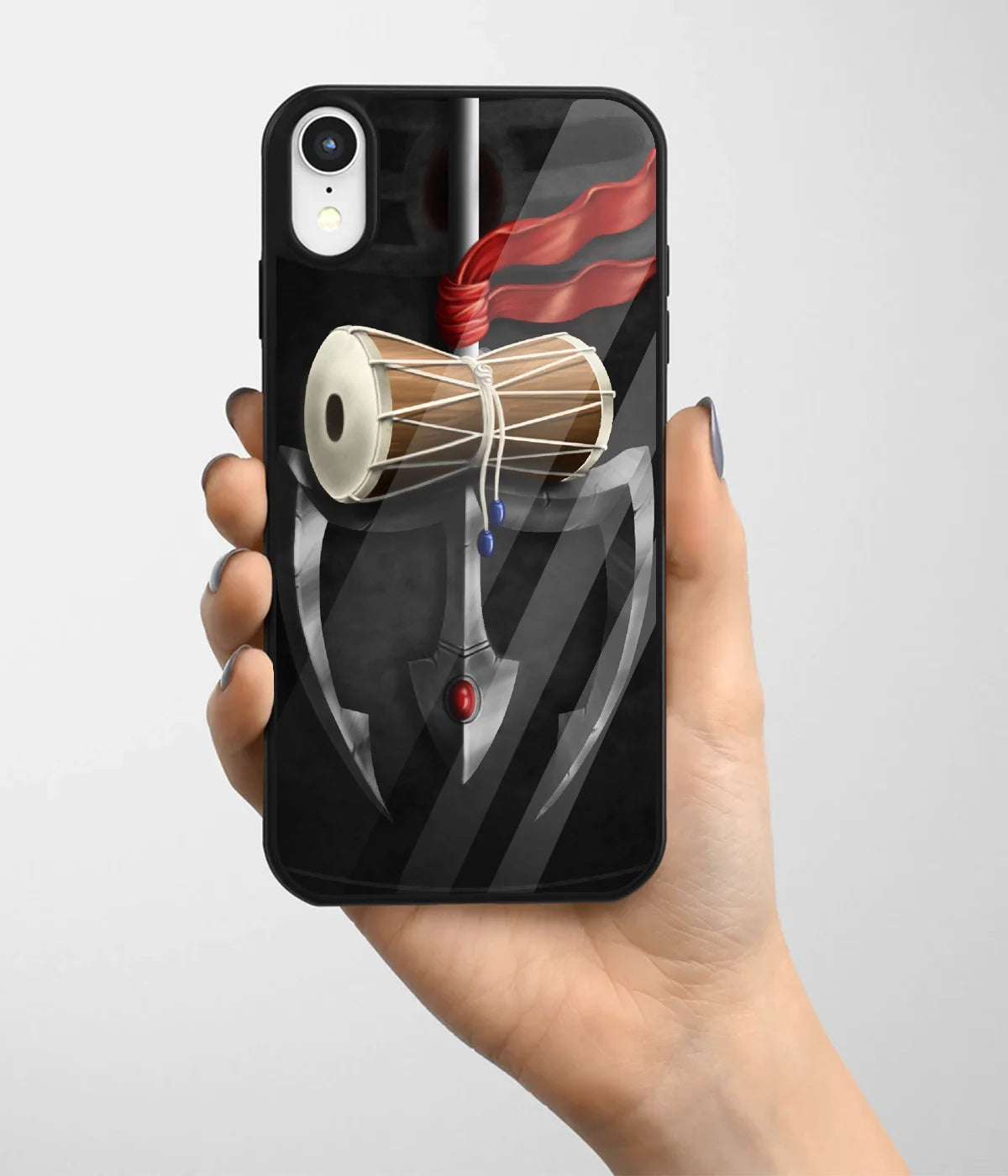 A hand holding a glass phone case with a colorful design.