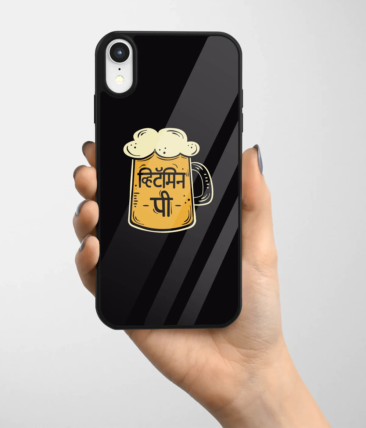 A hand holding a glass phone case with a colorful design.