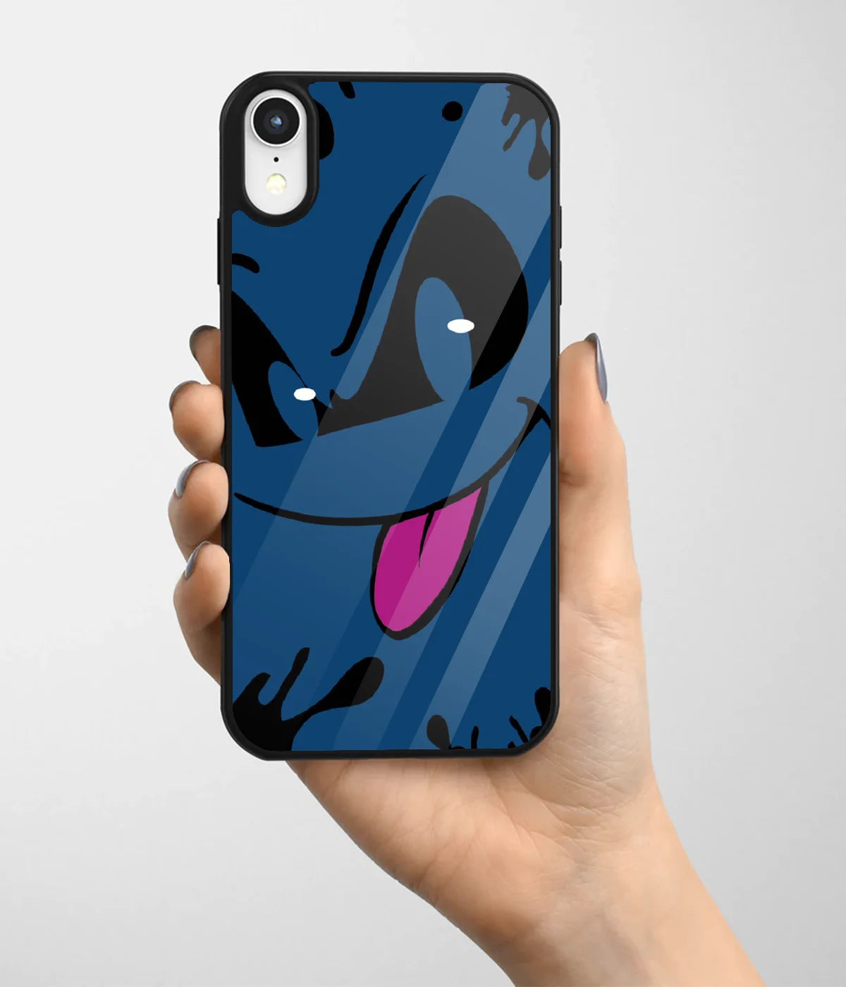 A hand holding a glass phone case with a colorful design.