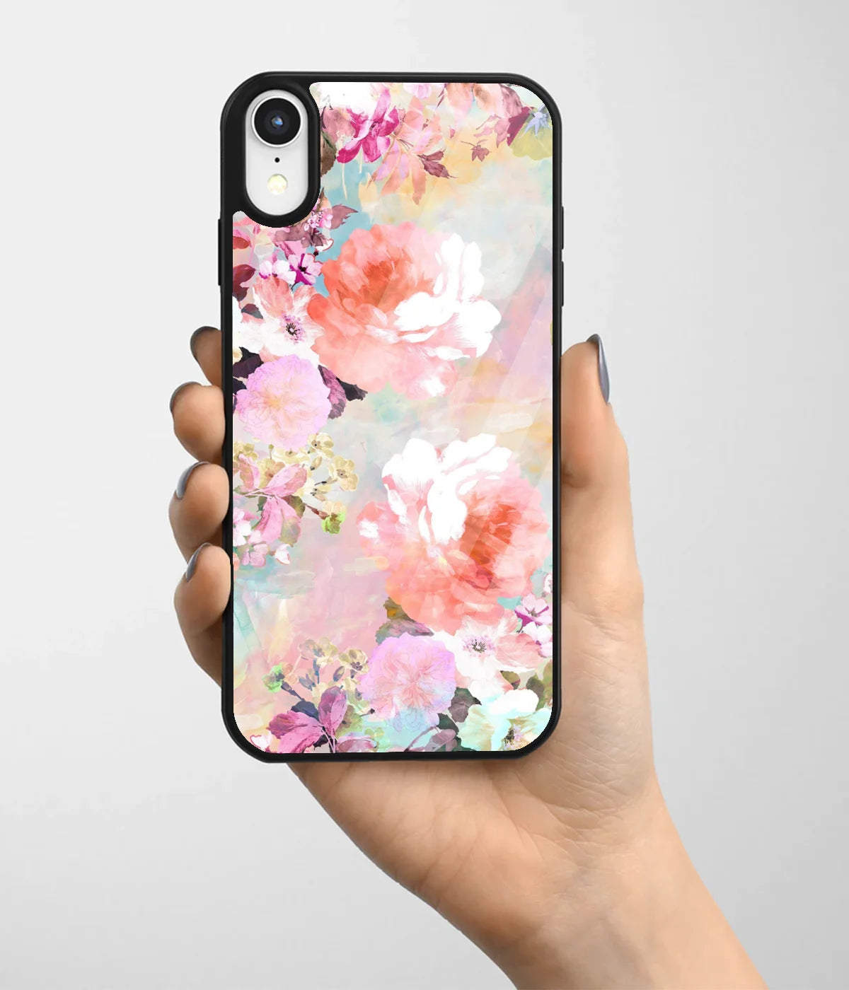 A hand holding a glass phone case with a colorful design.