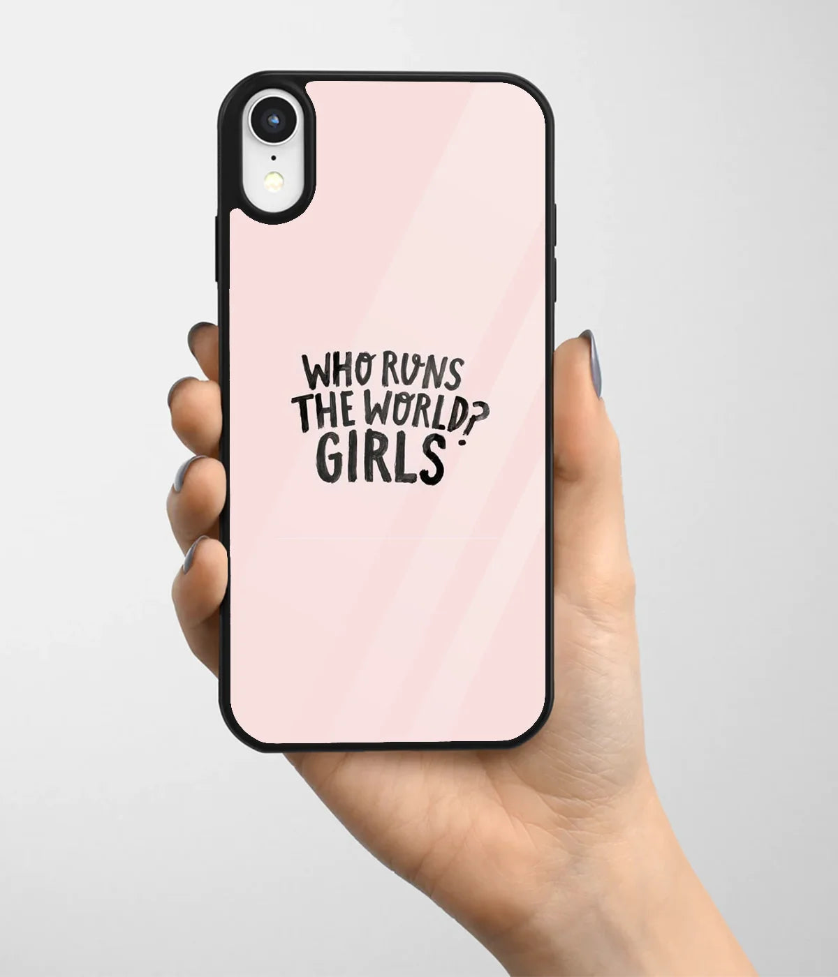 A hand holding a glass phone case with a colorful design.