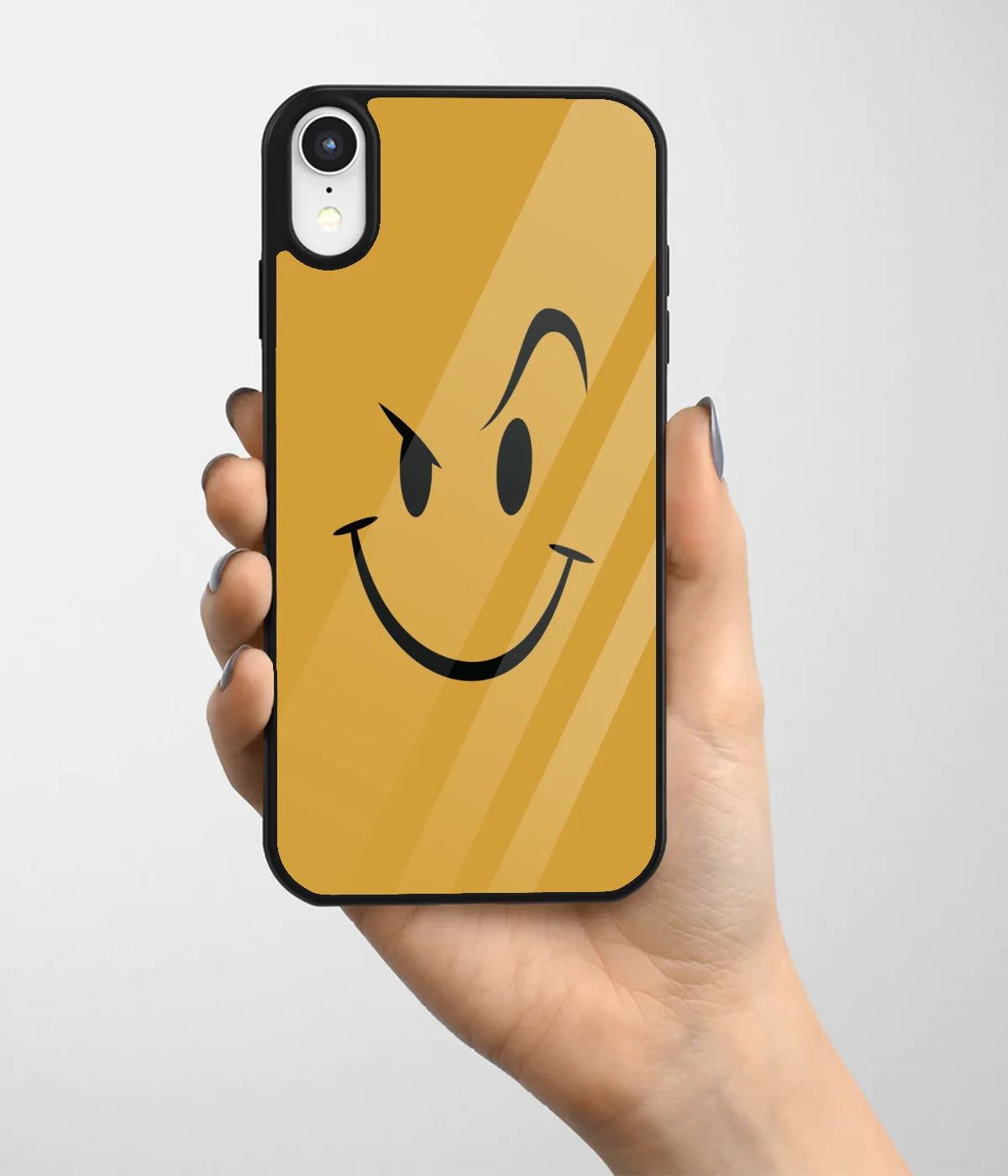 A hand holding a glass phone case with a colorful design.