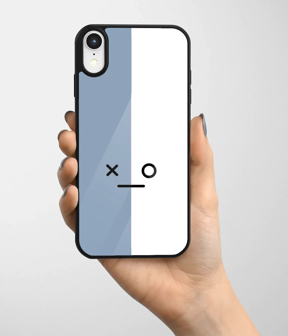 A hand holding a glass phone case with a colorful design.