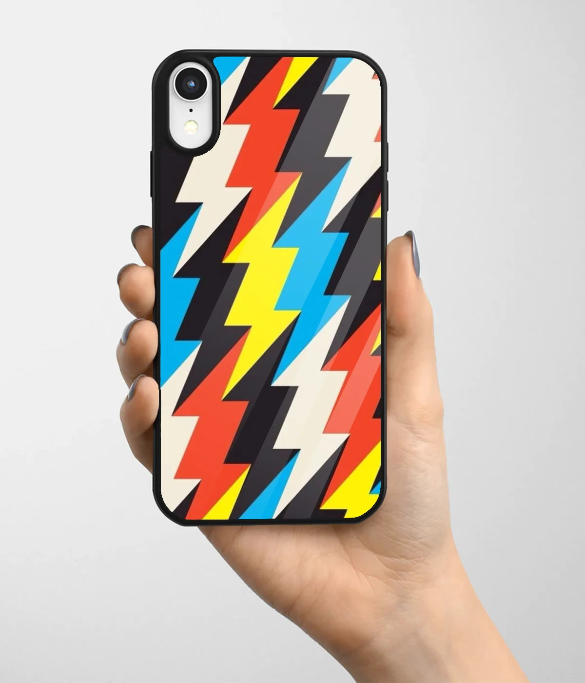 A hand holding a glass phone case with a colorful design.
