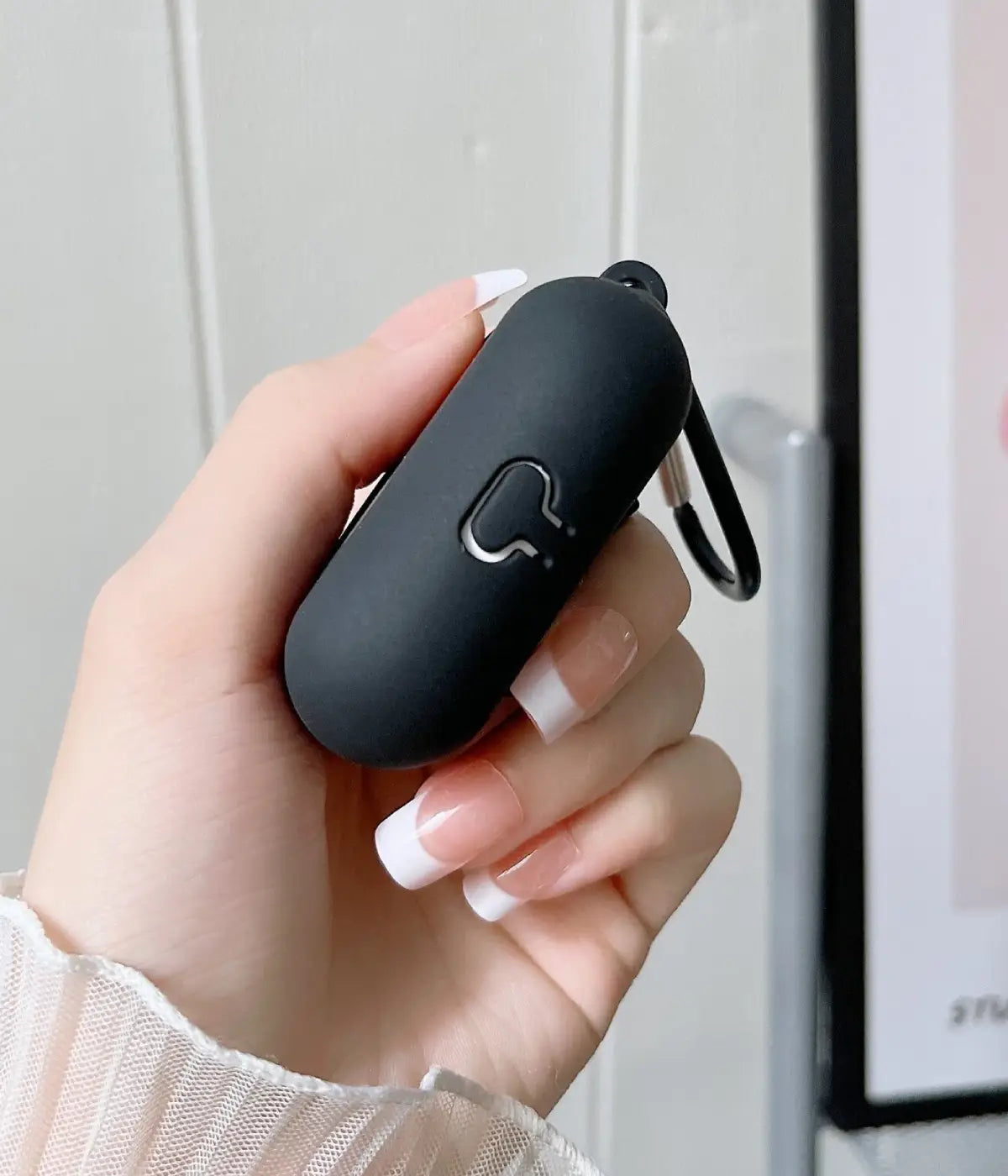 Close-up of a Black liquid silicone protective case for Apple AirPods held in a hand