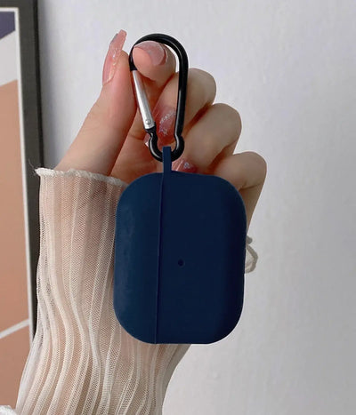 Deep Navy airpods case with carabiner held by a hand.