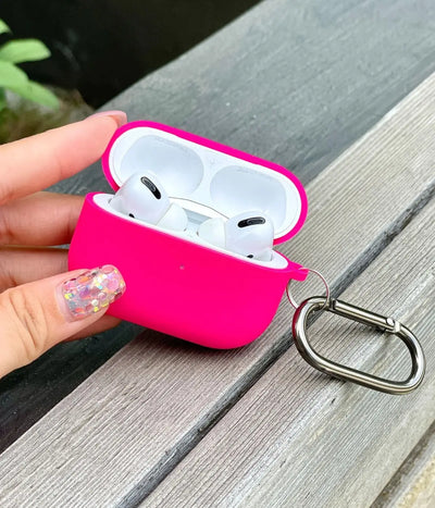 Hot Pink airpods case with carabiner held by a hand.