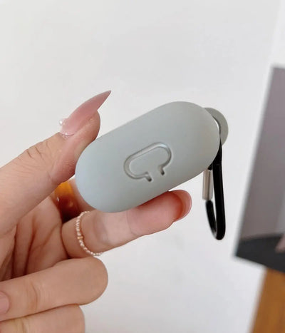 Light Grey airpods case with carabiner held by a hand.