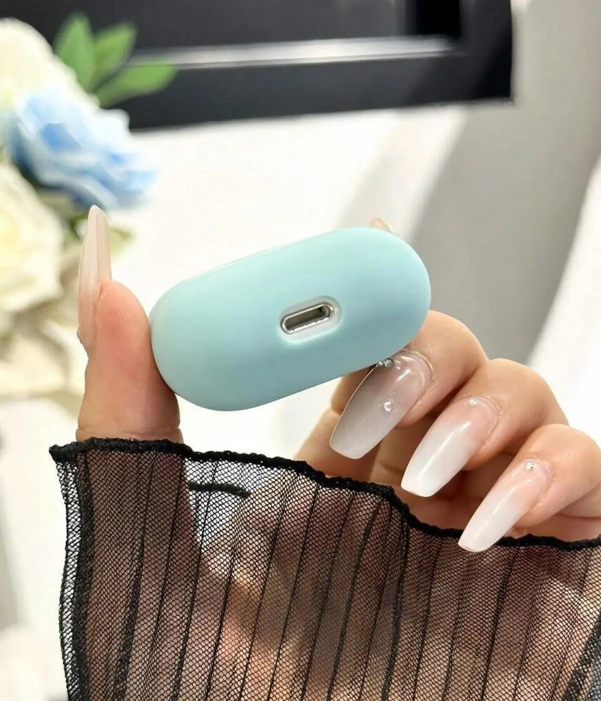 Close-up of a Seafome liquid silicone protective case for Apple AirPods held in a hand