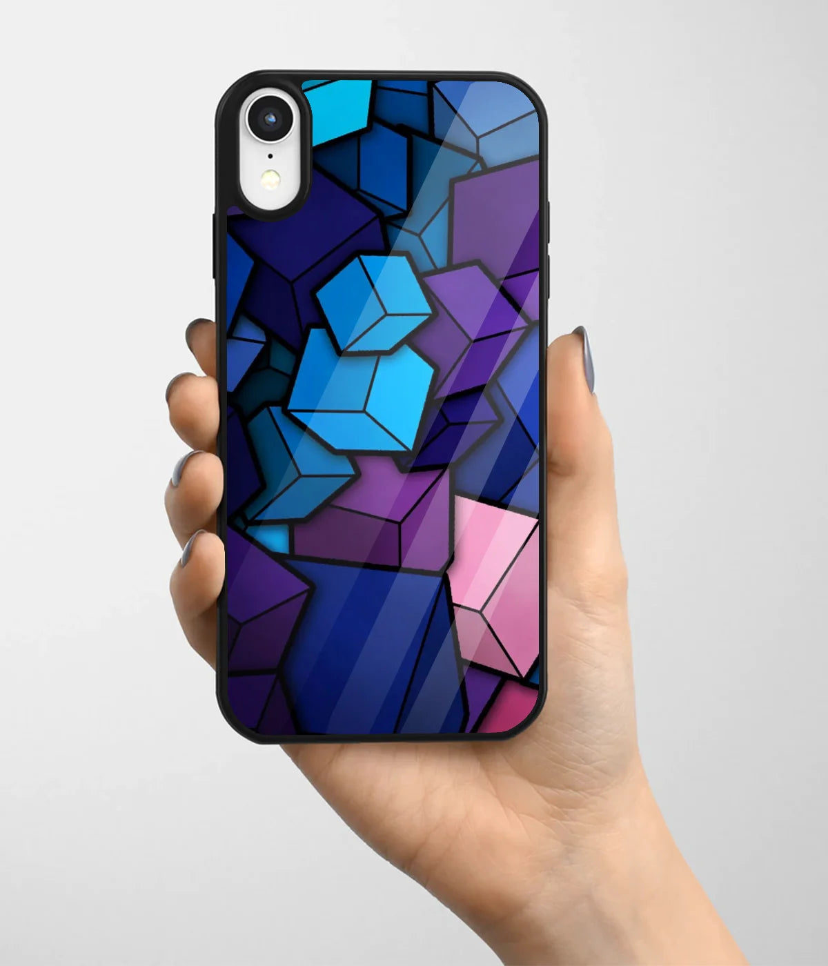 A hand holding a glass phone case with a colorful design.