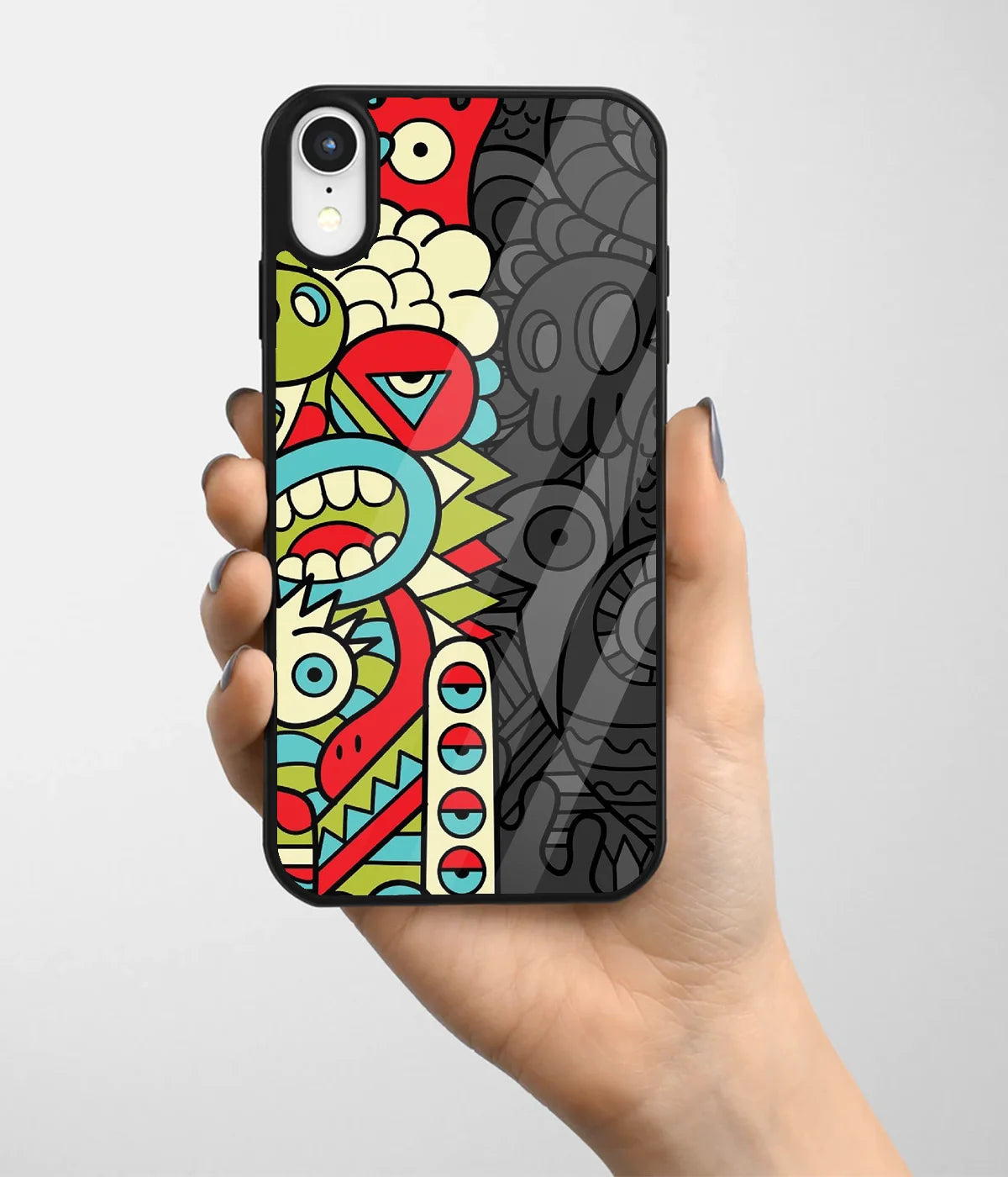 A hand holding a glass phone case with a colorful design.