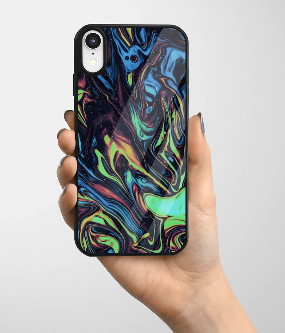A hand holding a glass phone case with a colorful design.