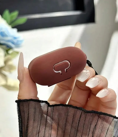 Close-up of a Brown liquid silicone protective case for Apple Airpods held in a hand
