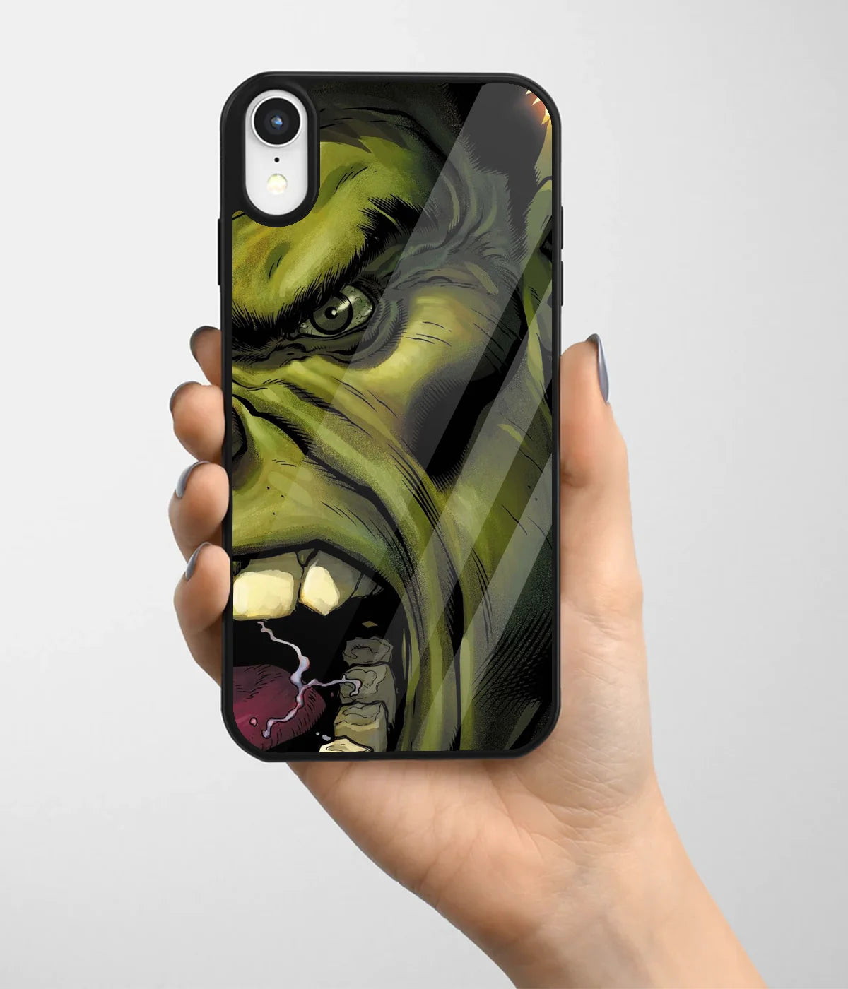 A hand holding a glass phone case with a colorful design.