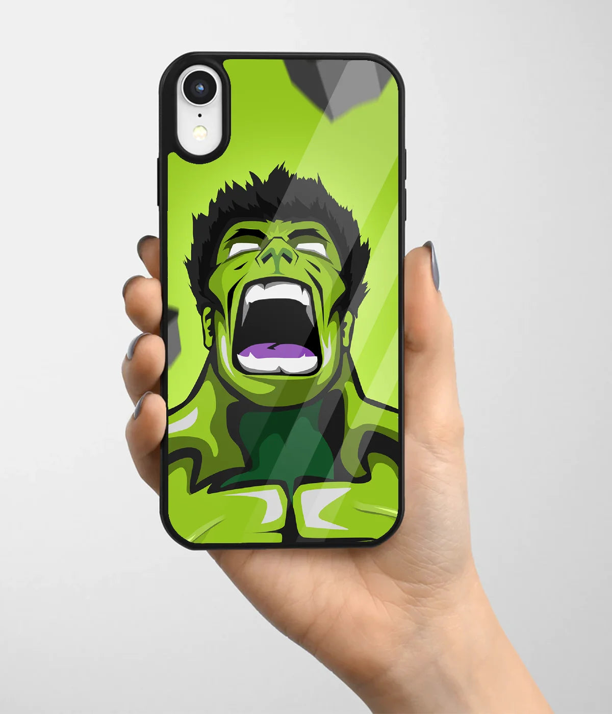 A hand holding a glass phone case with a colorful design.