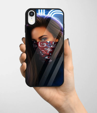 A hand holding a glass phone case with a colorful design.
