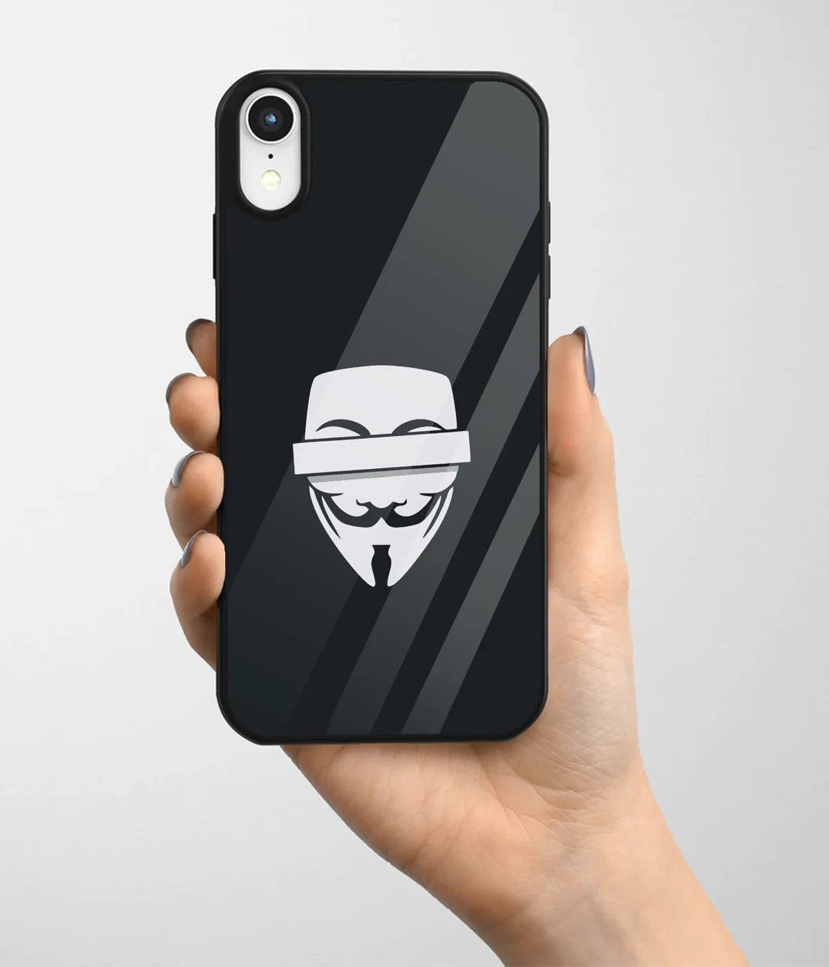 A hand holding a glass phone case with a colorful design.