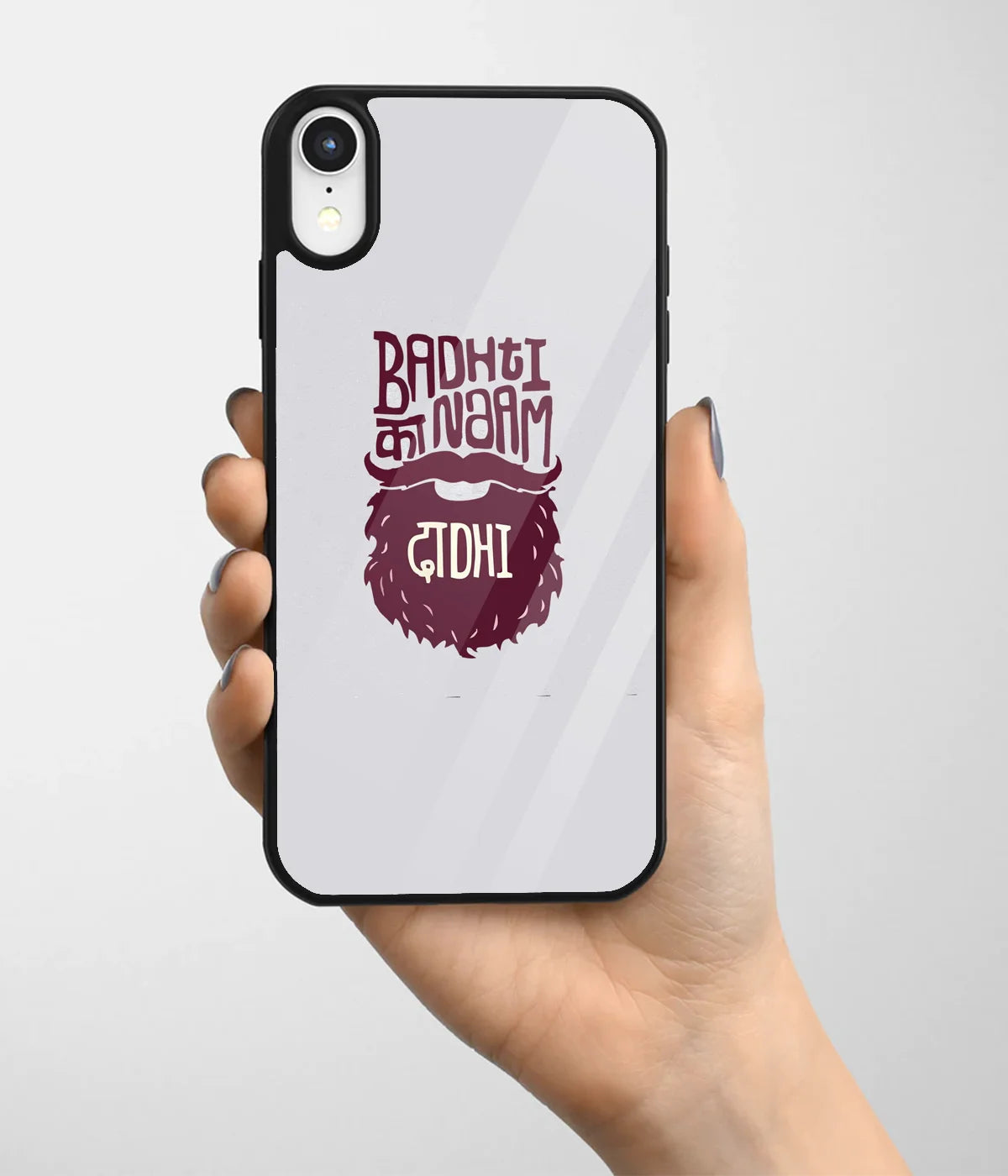 A hand holding a glass phone case with a colorful design.