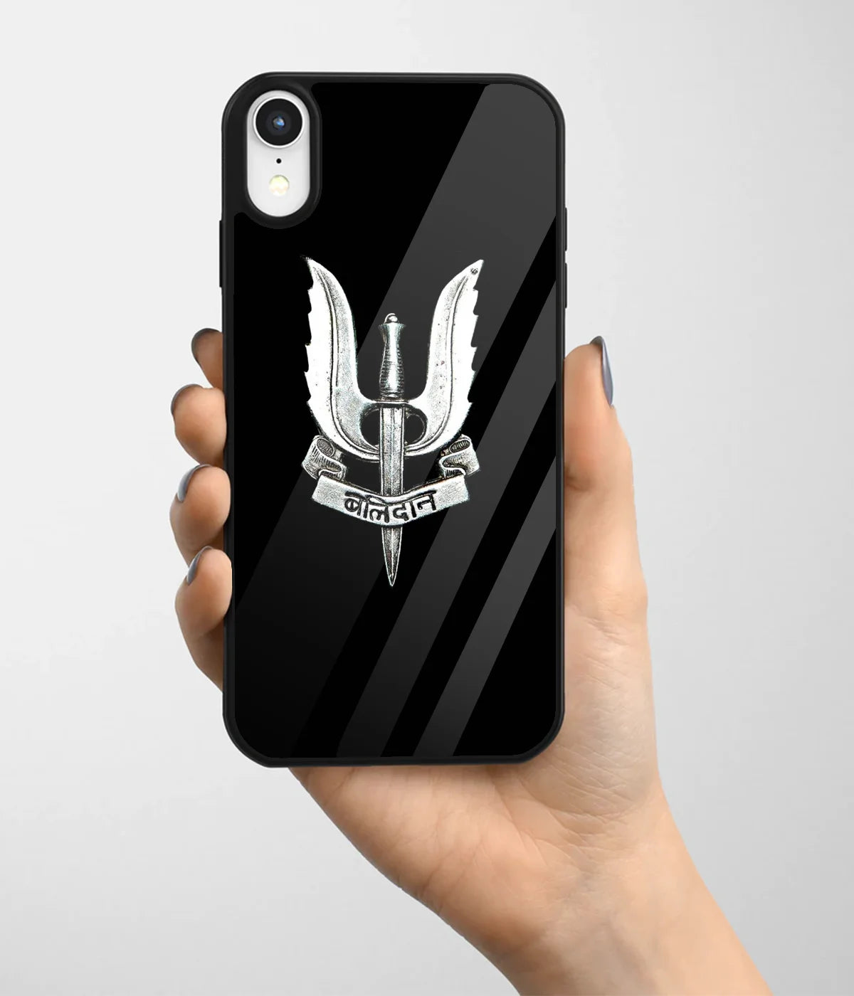 A hand holding a glass phone case with a colorful design.