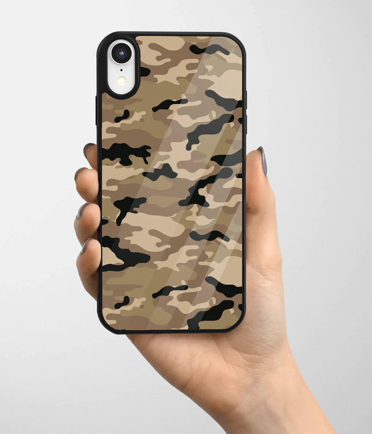 A hand holding a glass phone case with a colorful design.