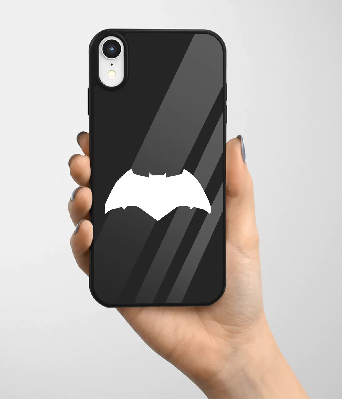 A hand holding a glass phone case with a colorful design.