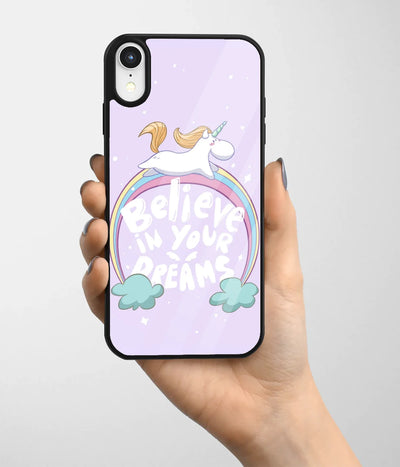 A hand holding a glass phone case with a colorful design.