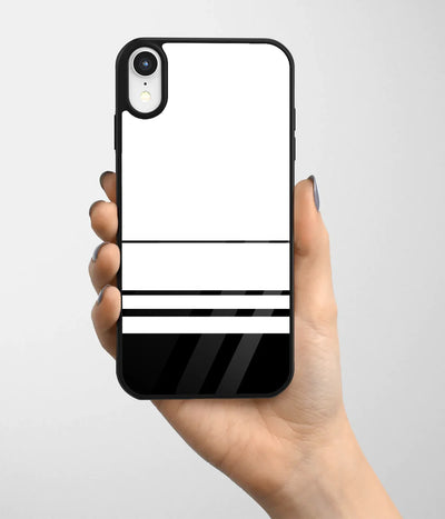 A hand holding a glass phone case with a colorful design.
