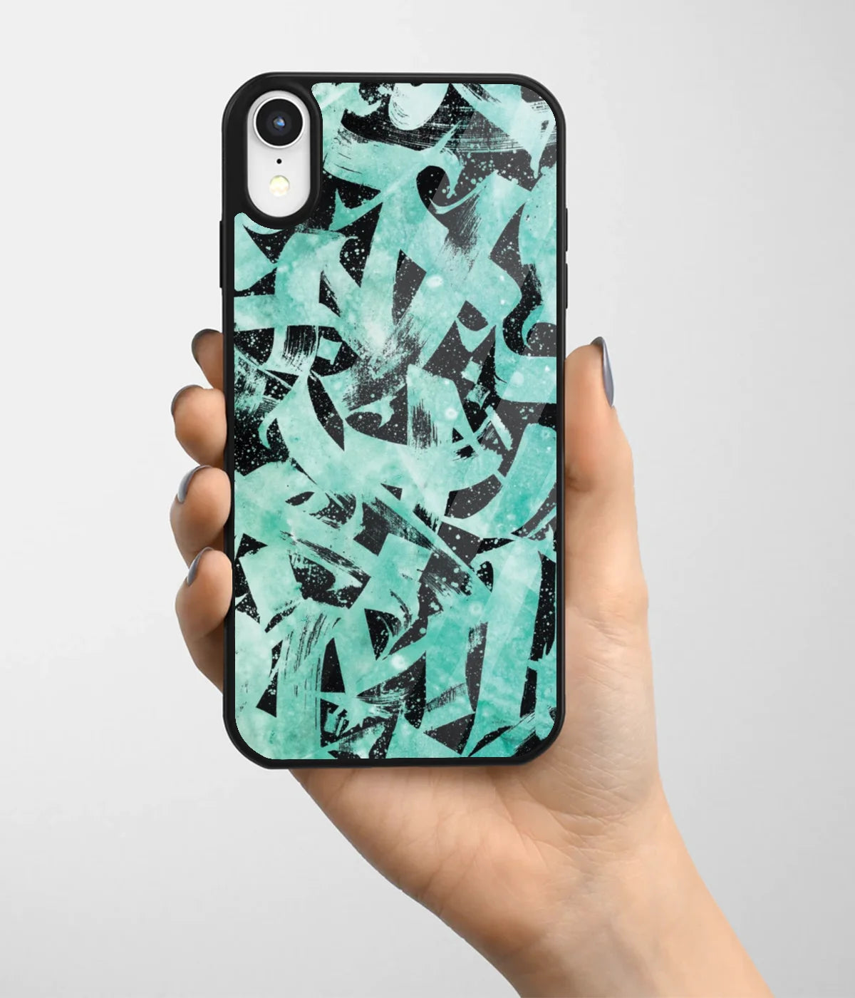 A hand holding a glass phone case with a colorful design.