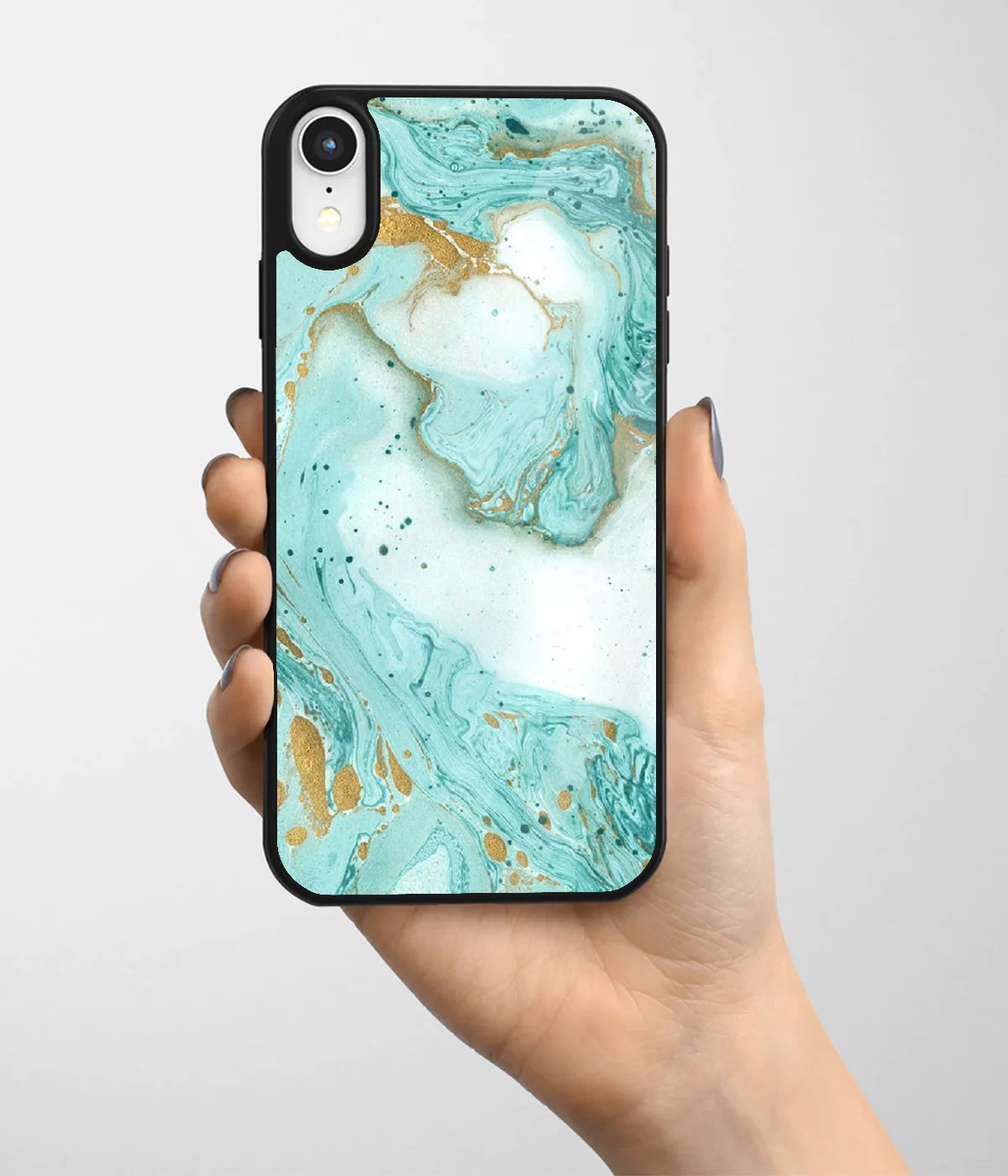 A hand holding a glass phone case with a colorful design.