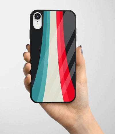 A hand holding a glass phone case with a colorful design.