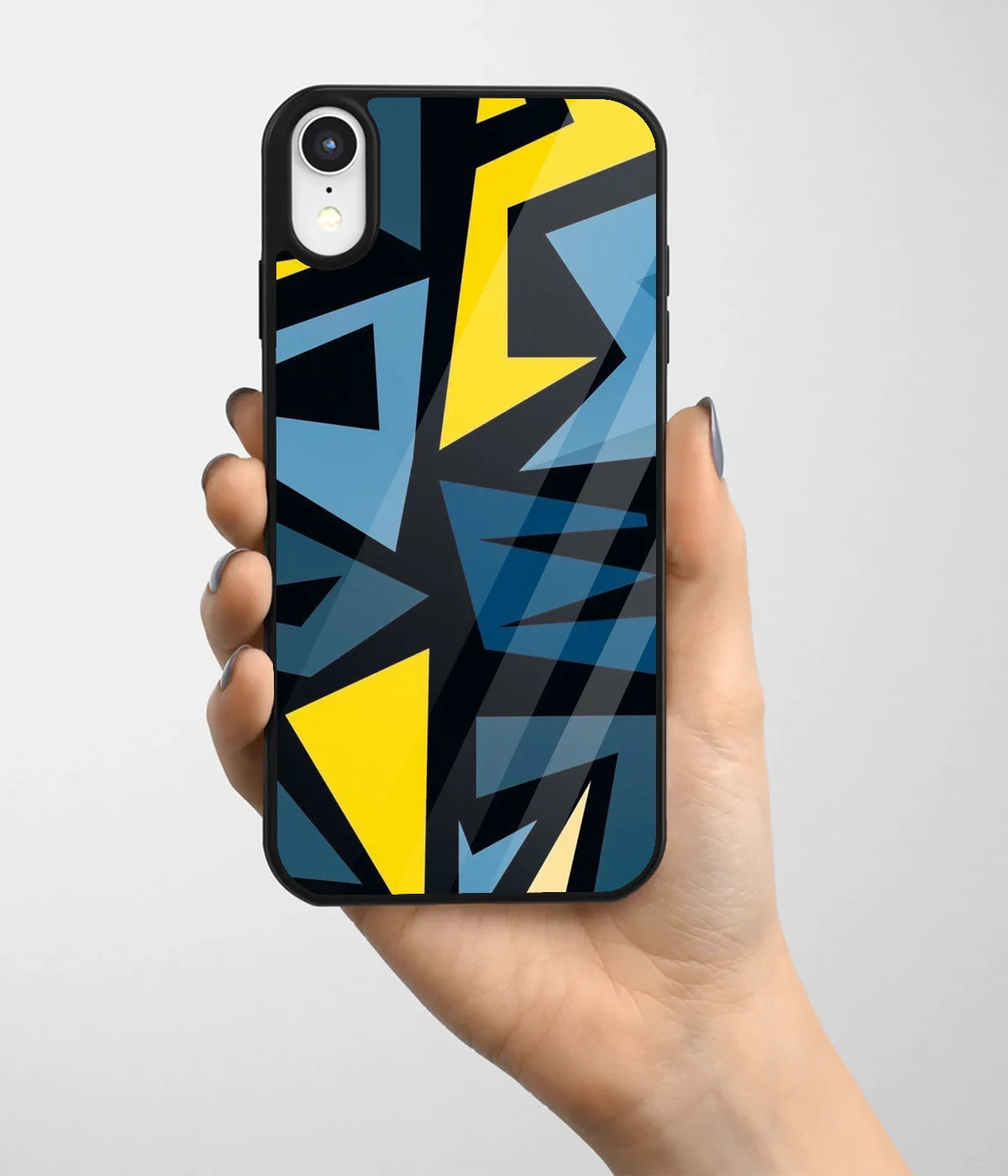 A hand holding a glass phone case with a colorful design.