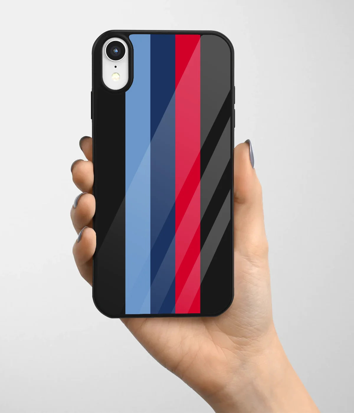 A hand holding a glass phone case with a colorful design.